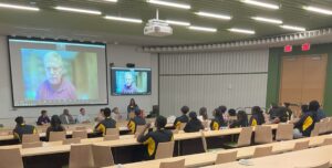 students in STEM Ready shirts watching professor present